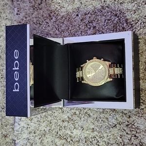 Bebe women's watch gold with rhinestones with original case for storage.